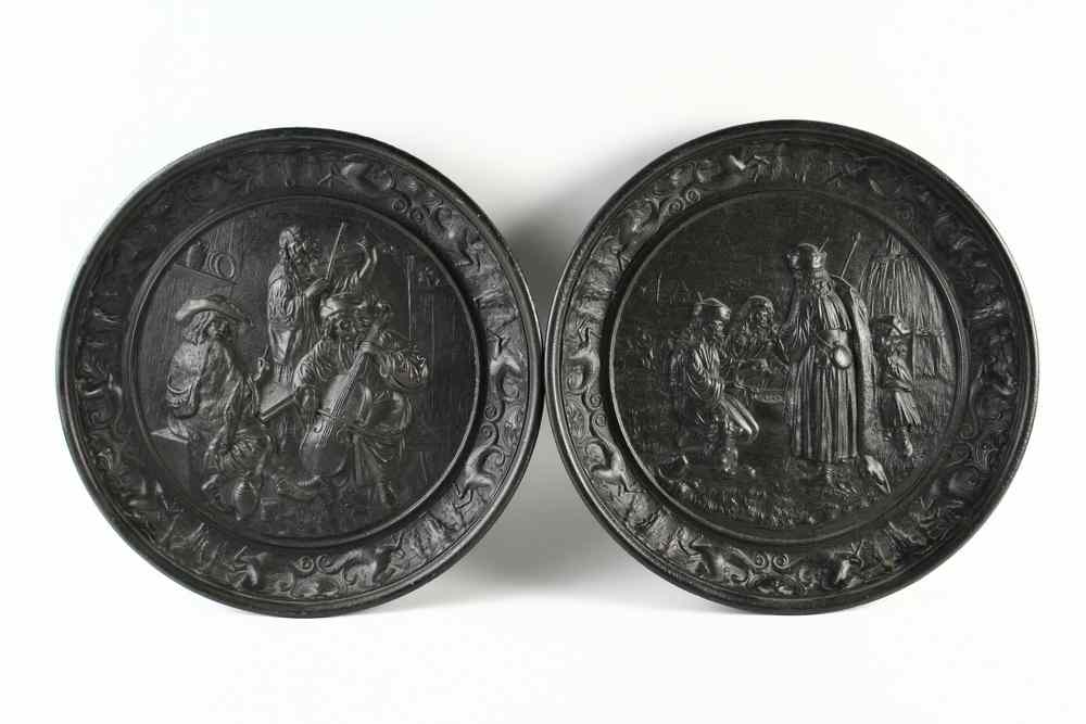 Appraisal: WALL CHARGERS - Pair of th c cast iron repousse