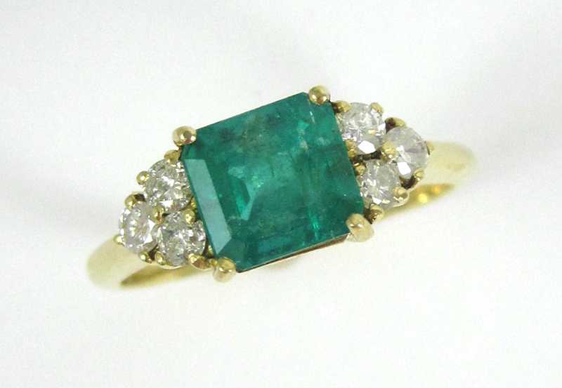 Appraisal: EMERALD DIAMOND AND EIGHTEEN KARAT GOLD RING with three round-cut