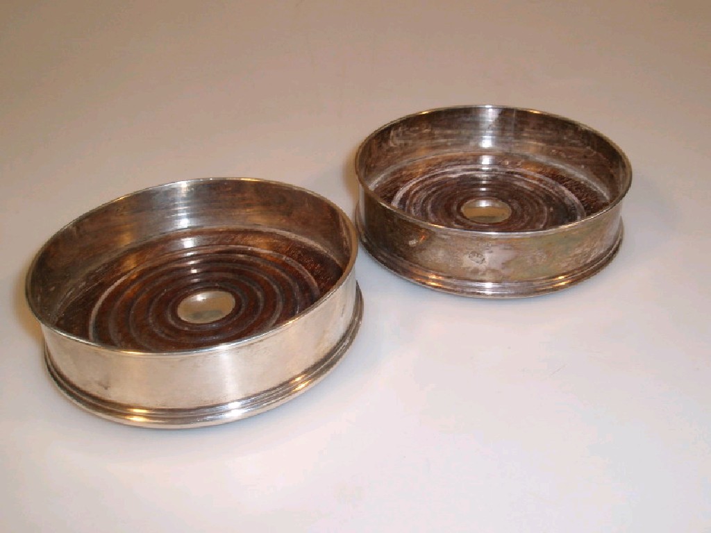 Appraisal: A pair of plain silver wine coasters scatter marks for