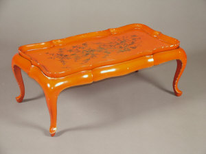 Appraisal: A red lacquered coffee table together with a square tray