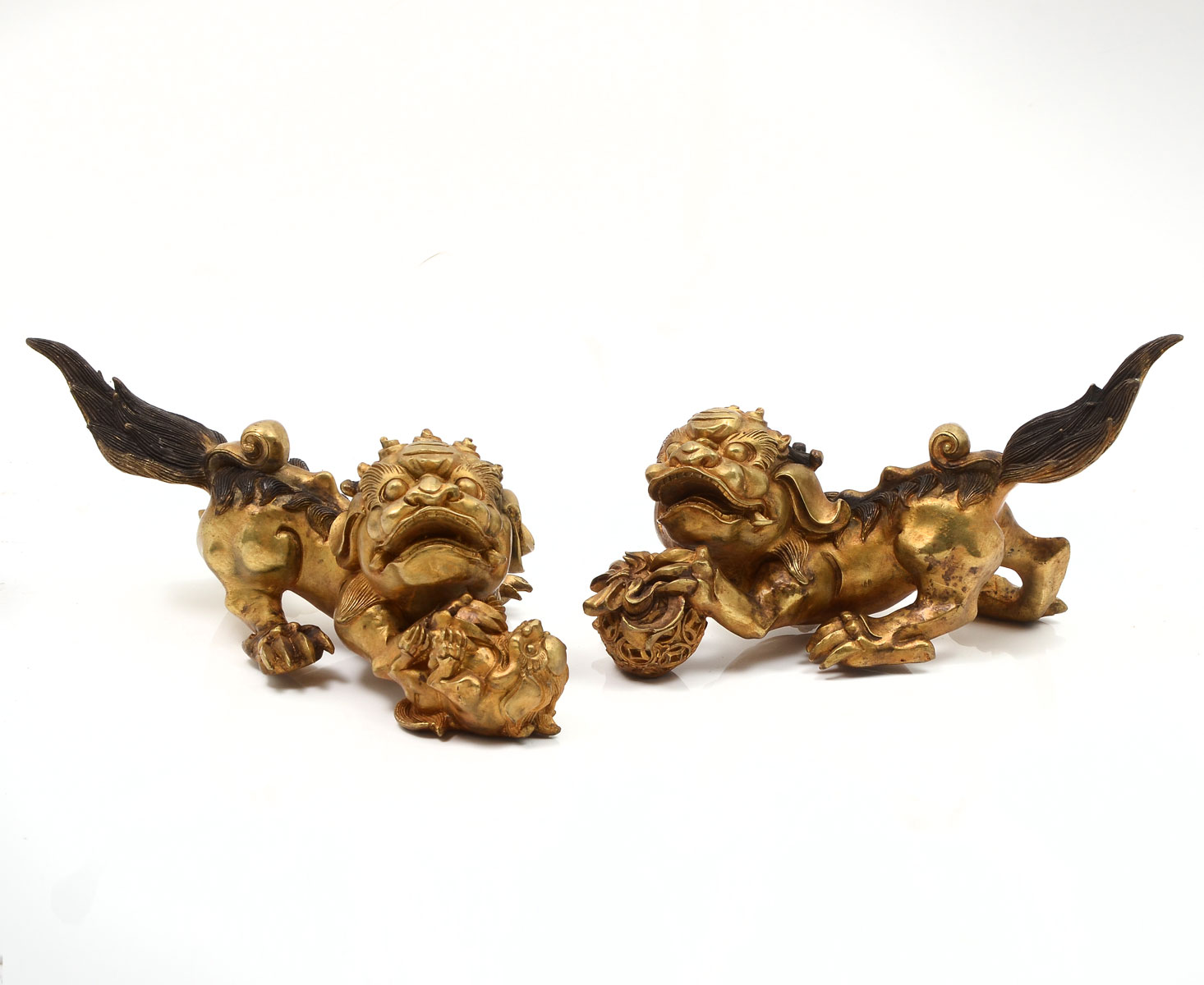 Appraisal: GILT BRONZE FOO DOGS Set of male and female hand-chased