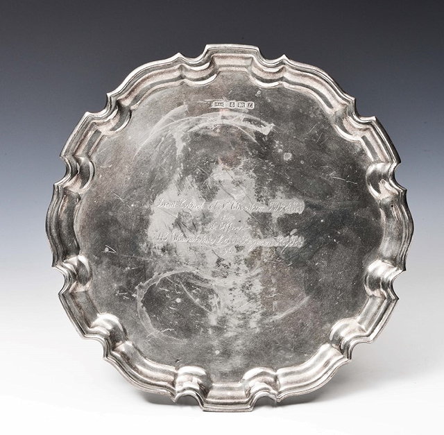 Appraisal: A SILVER SALVER with a Chippendale border and three cabriole