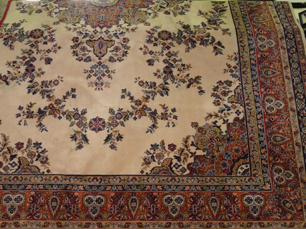 Appraisal: An Axminster style Indian design carpet with a shaped central