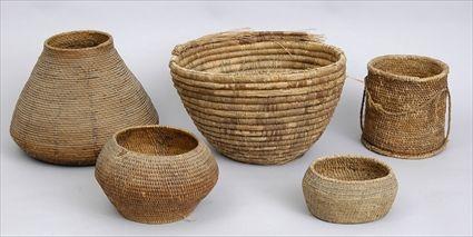 Appraisal: FIVE COILED BASKETS Comprising conical tapered cushion-form oval and cylindrical