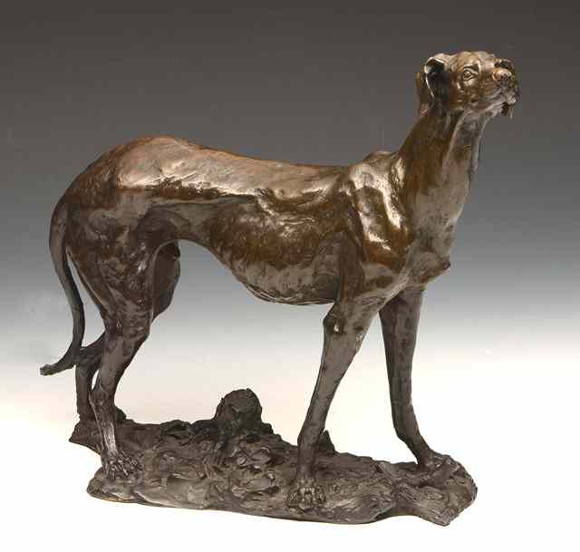 Appraisal: A BRONZE FIGURE of a grey hound standing on rough