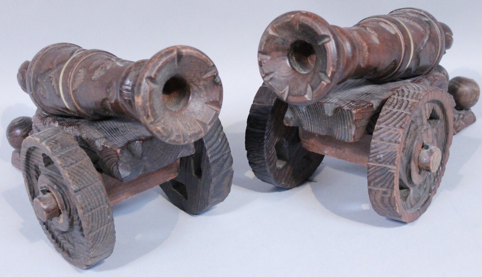 Appraisal: A pair of modern carved wooden table cannons each with