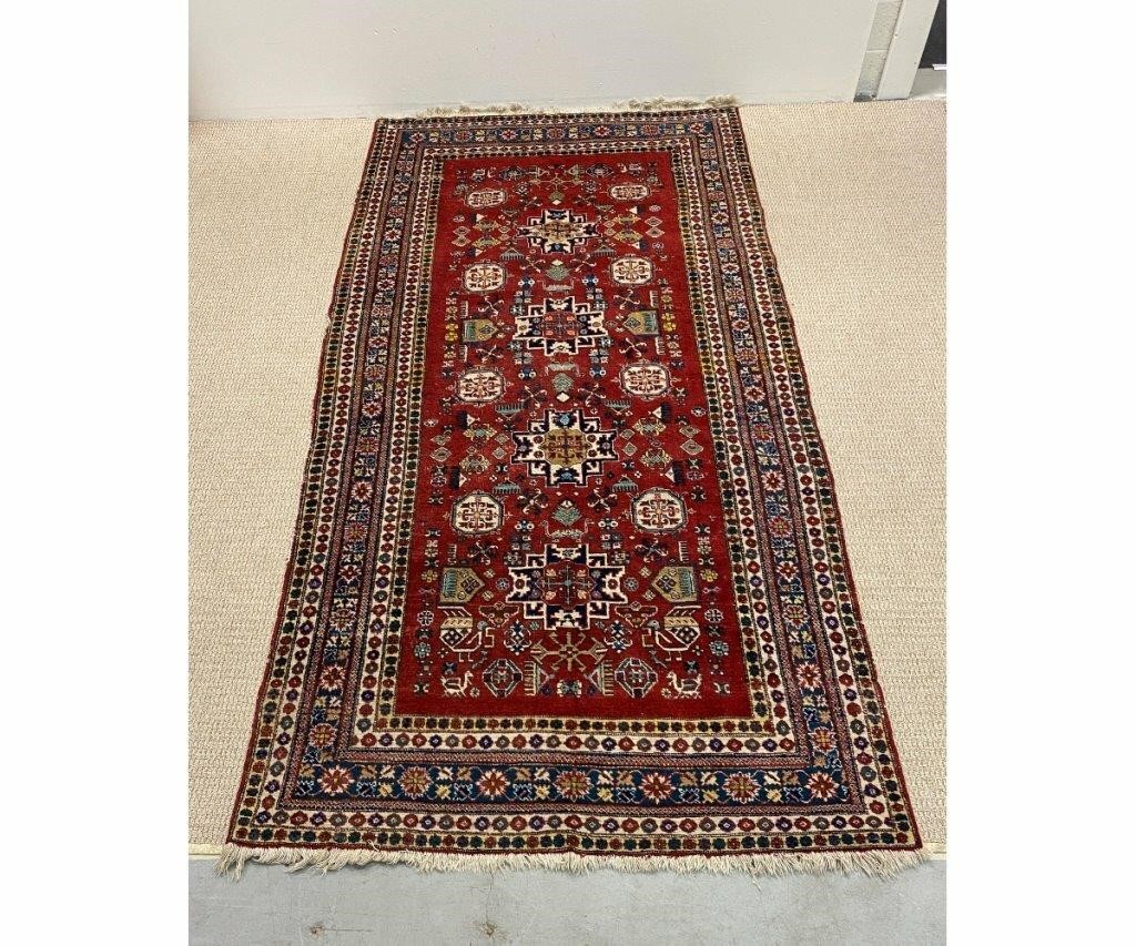 Appraisal: Persian center hall carped with red field floral pattern '-