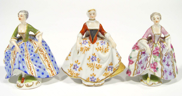 Appraisal: Three miniature Continental porcelain figurines in floral patterned dresses factory