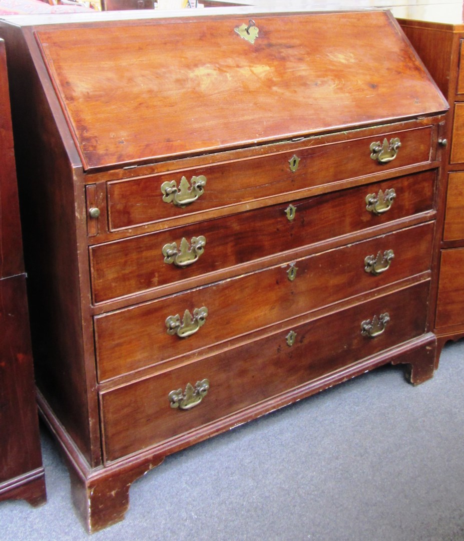 Appraisal: A George III mahogany bureau the fall enclosing a fitted