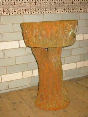 Appraisal: A SET OF THREE TERRACOTTA PLANTERS in a tree bark