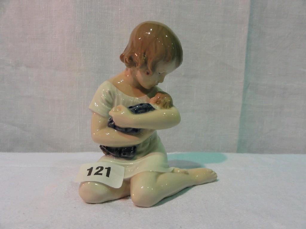 Appraisal: A Royal Copenhagen figure of a little girl seated and