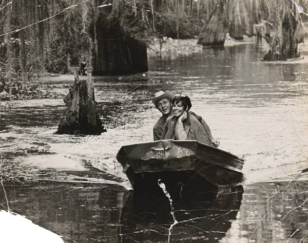 Appraisal: A photograph of Neile and Steve McQueen paddling in a