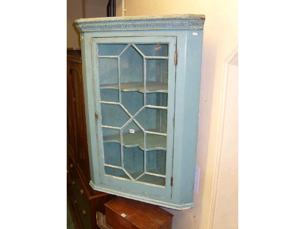 Appraisal: A Georgian mahogany hanging corner display cabinet enclosed by an