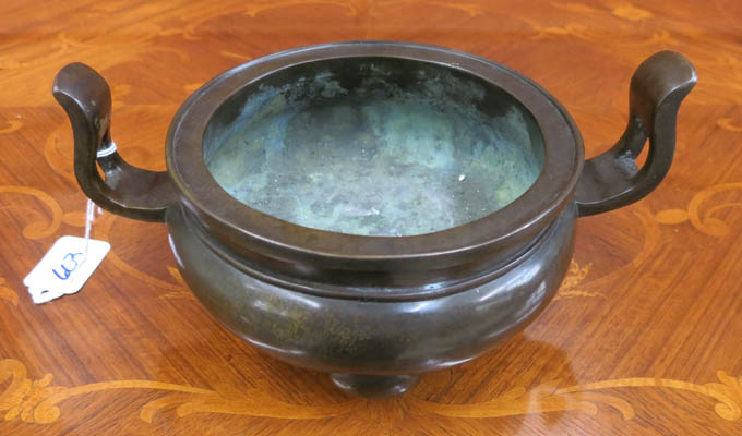 Appraisal: CHINESE BRONZE HANDLED CENSER with tributary reign mark and resting