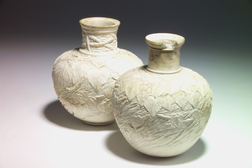 Appraisal: TIFFANY Two bisque-fired bulbous vases of white clay modeled with