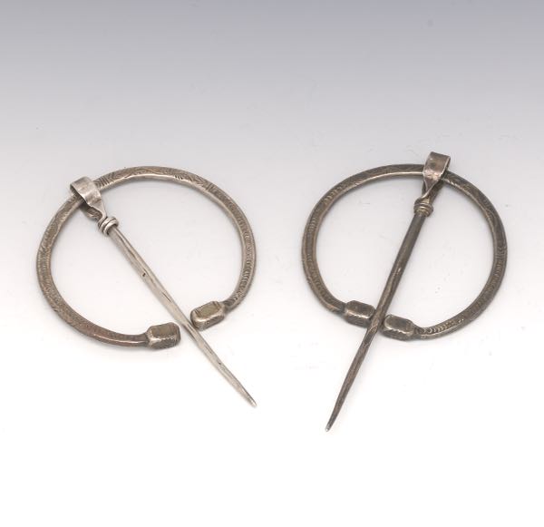 Appraisal: TWO STERLING ANTIQUE CELTIC PENANNULAR BROOCHES each with and pins