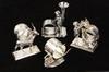 Appraisal: FIGURAL SILVER PLATE NAPKIN RINGS - Including Cherub holding bud