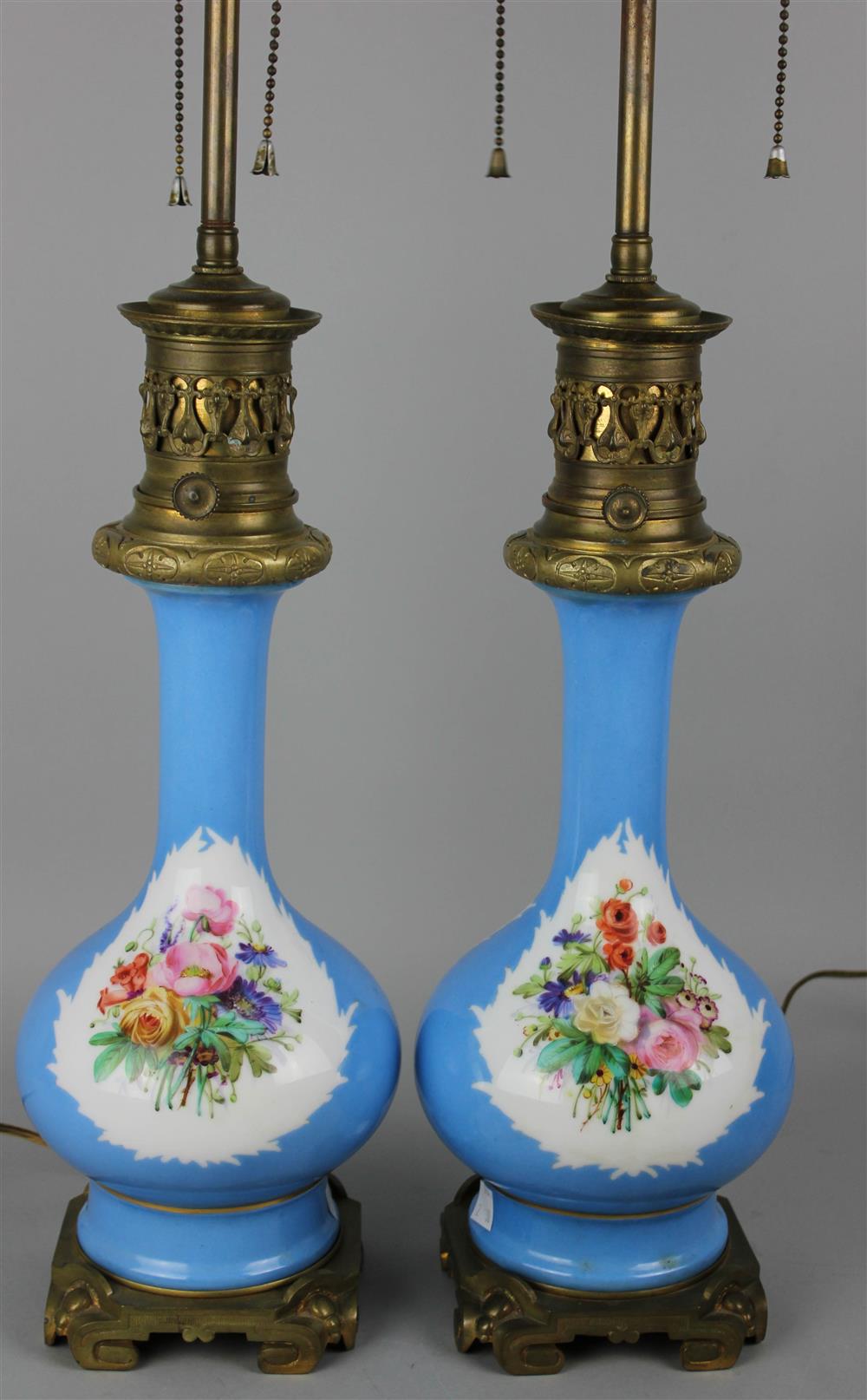 Appraisal: PAIR OF FRENCH ORMOLU MOUNTED FLORAL DECORATED PORCELAIN CONVERTED OIL