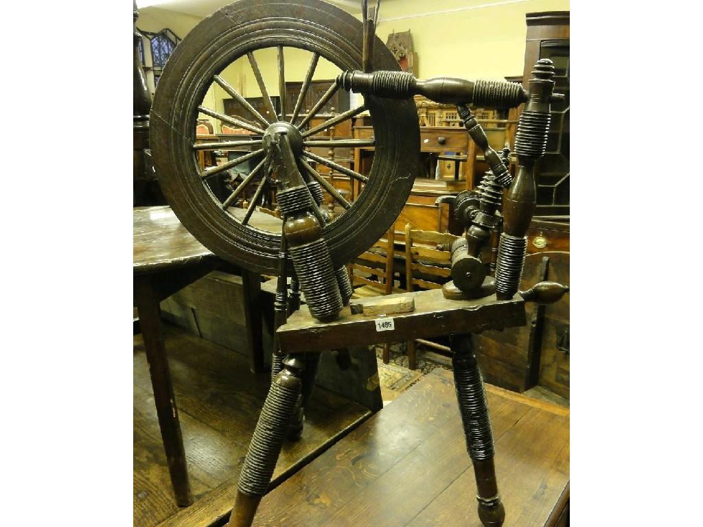 Appraisal: A th century oak spinning wheel with ring turnings and