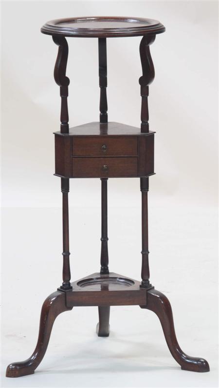 Appraisal: A circular mahogany washstand in the mid th century manner