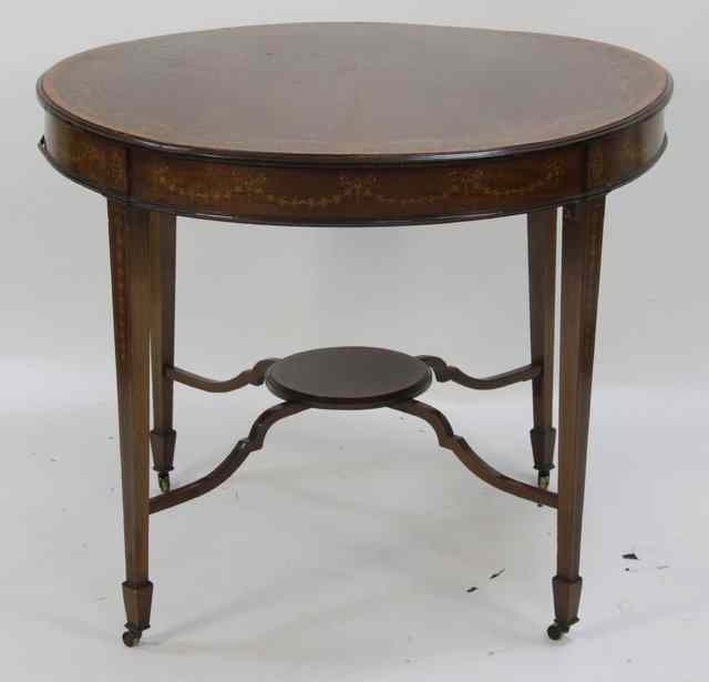 Appraisal: An Edwardian mahogany and inlaid circular occasional table the ribbon