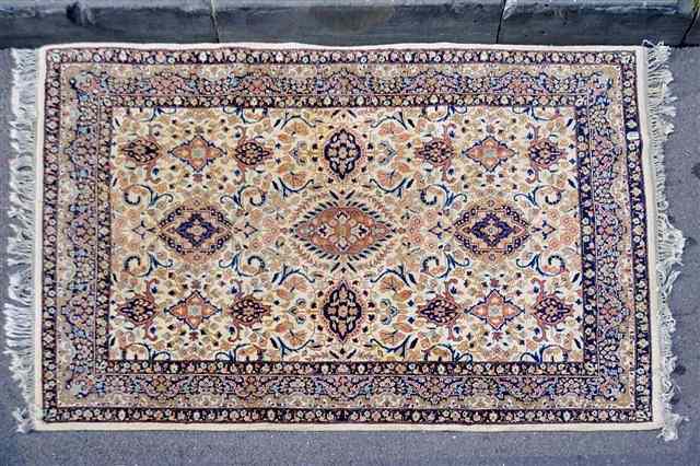 Appraisal: A PERSIAN TABRIZ DESIGN RUG decorated a central medallion on