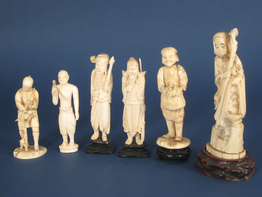 Appraisal: Pair of Japanese carved ivory Standing Bearded Figures with blades