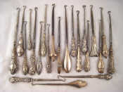 Appraisal: A collection of silver handled button hooks together with one