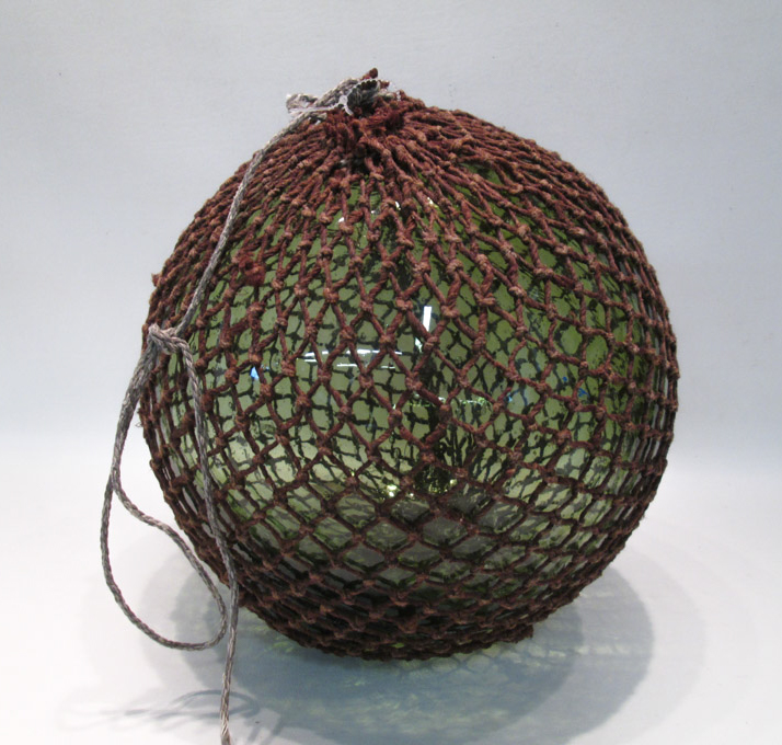 Appraisal: JAPANESE GLASS FISHING FLOAT green glass with rope netting Diameter