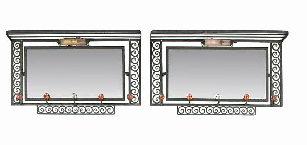 Appraisal: A pair of Art Deco wrought-iron glass and mirrored-back coat