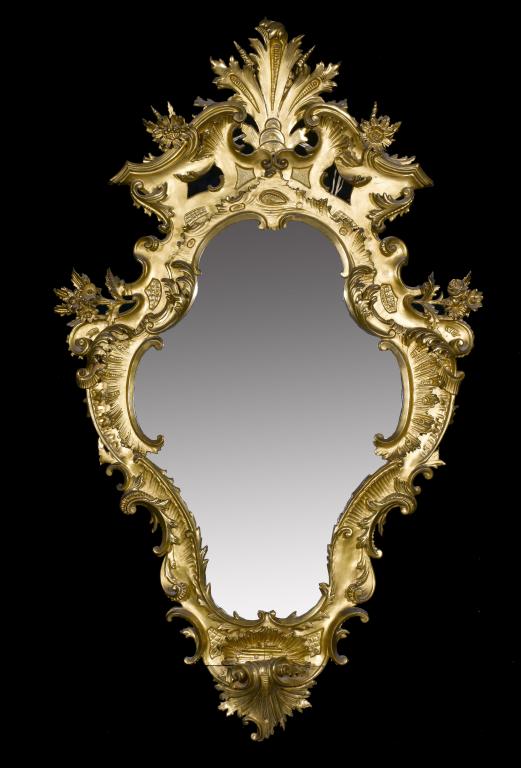 Appraisal: AN ITALIAN GILTWOOD MIRROR cartouche shaped with pierced volute cresting