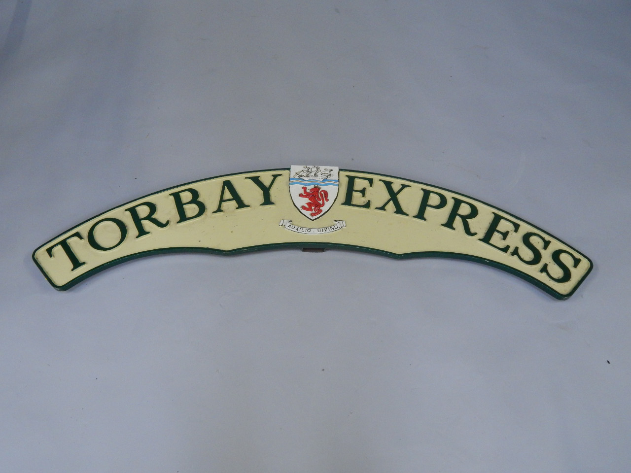 Appraisal: A cast metal and enamel replica train headboard Torbay Express