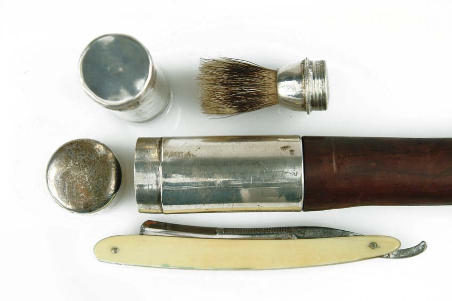 Appraisal: TOILETRY CANE Hallmarked silver top containing shaving brush razor fits