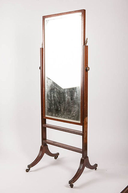 Appraisal: A MAHOGANY CHEVAL MIRROR with rectangular plate standing on outswept