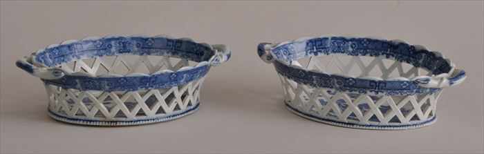 Appraisal: PAIR OF ENGLISH TRANSFER-PRINTED RETICULATED OVAL TWO-HANDLED BASKETS In the