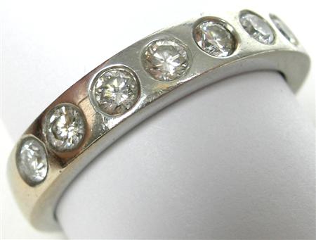 Appraisal: A platinum mounted diamond half-eternity ring inset to the front