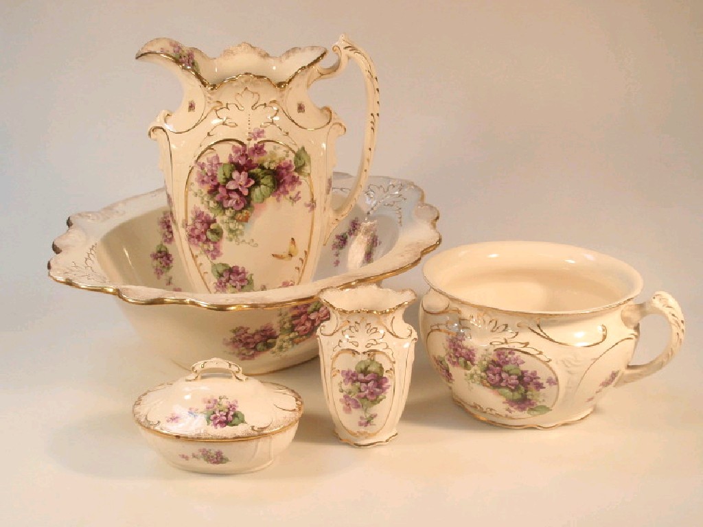 Appraisal: An Edwardian pottery toilet service comprising bowl ewers chamber pot