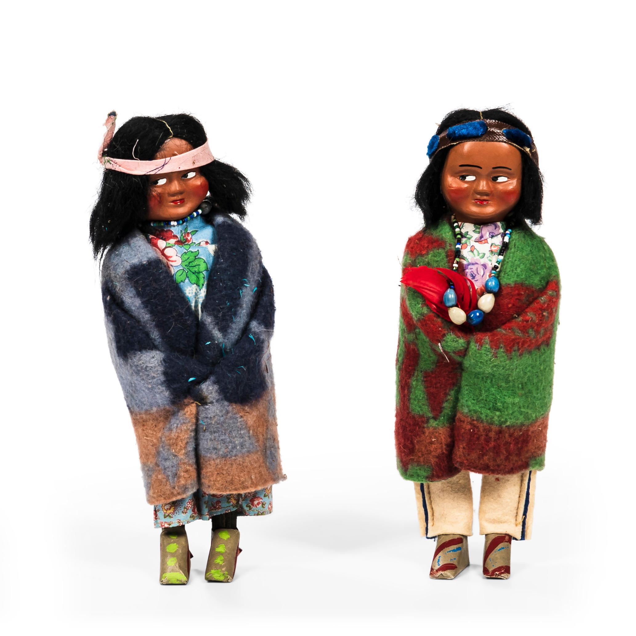 Appraisal: TWO SKOOKUM DOLLS composition heads with wool and felt costume