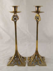 Appraisal: A pair of cast brass tall candlesticks closely modelled on