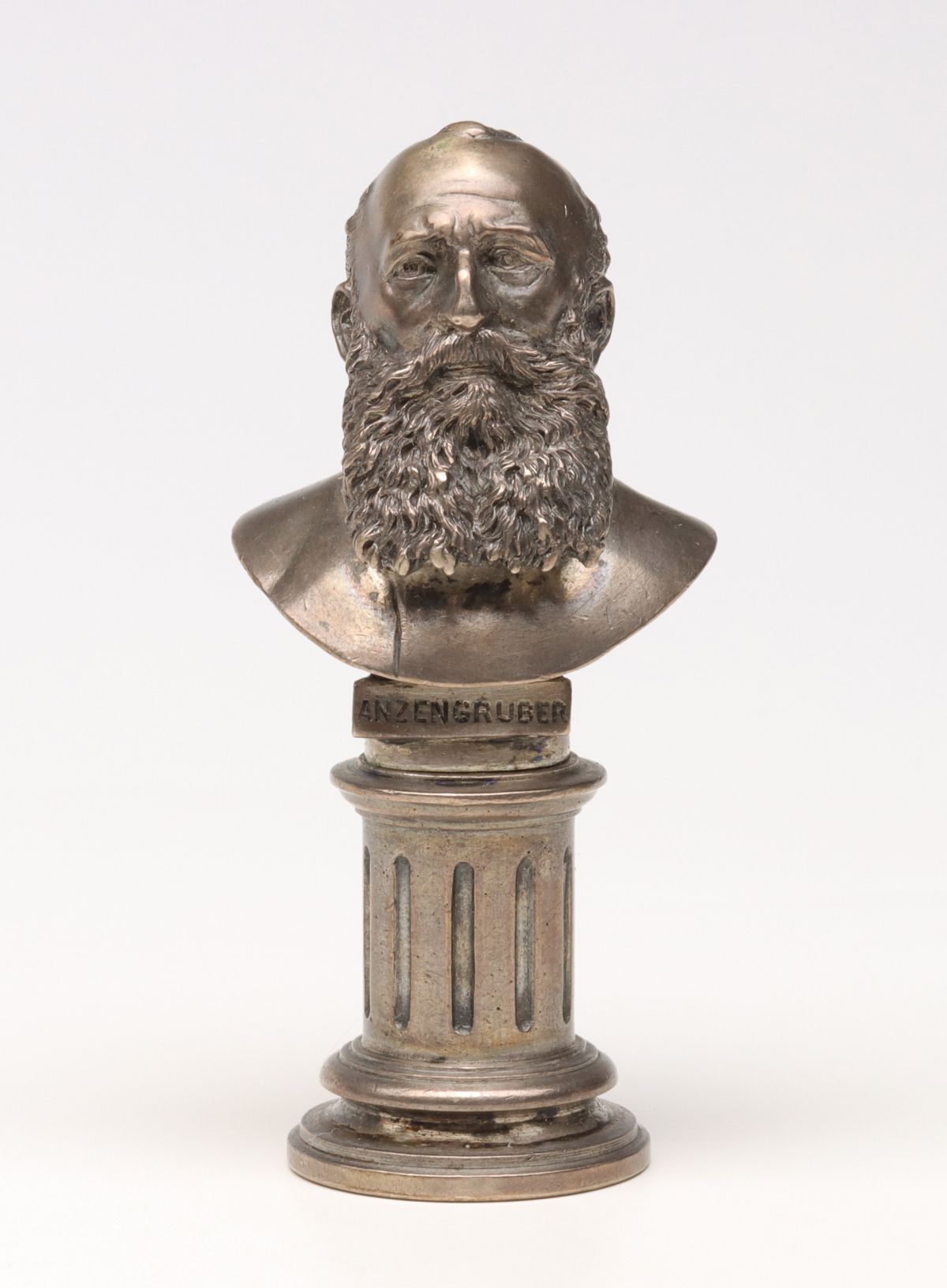 Appraisal: SILVER PLATED BUST OF ANZENGRUBER ON ANTIQUE WAX SEALThe detailed