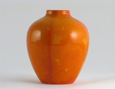 Appraisal: A Chinese tangerine-coloured glass ovoid jar the metal with a