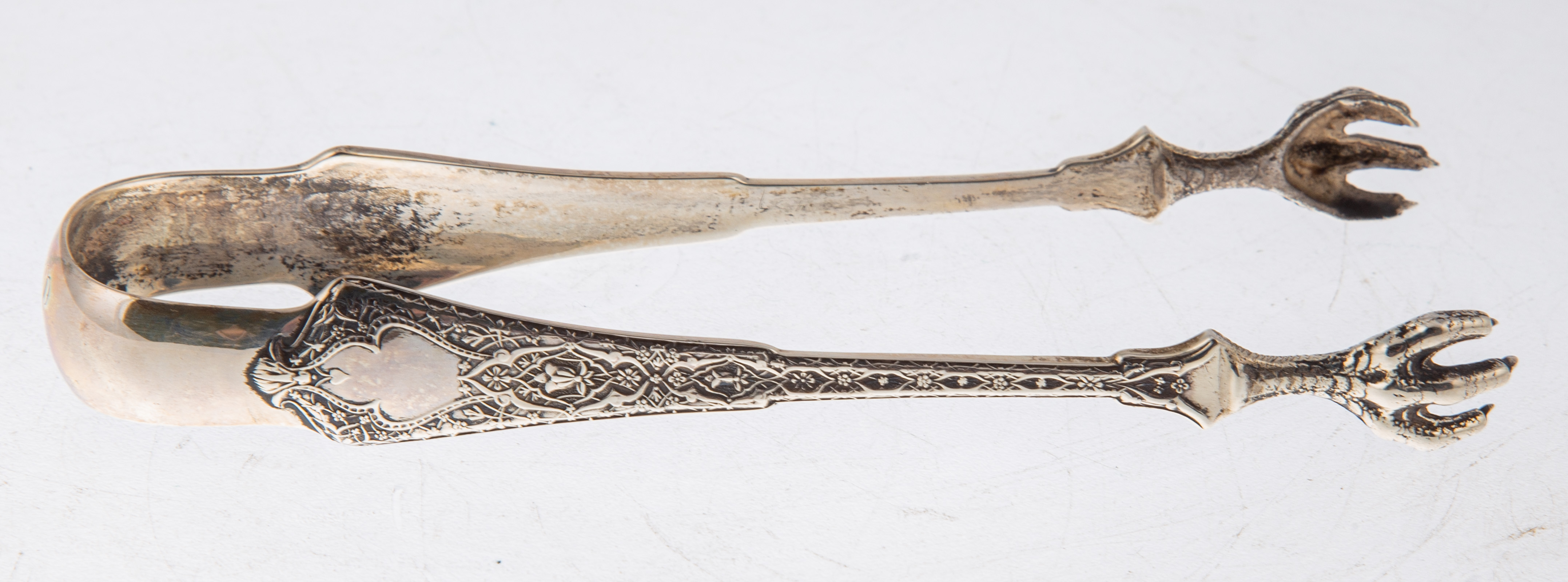 Appraisal: TIFFANY CO STERLING PERSIAN SUGAR TONGS Monogrammed in L ozt