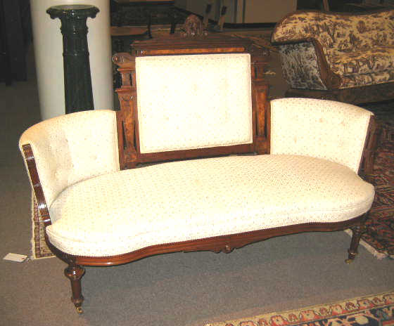 Appraisal: AMERICAN RENAISSANCE REVIVAL WALNUT JELIFF SETTEE The architectural crest centers