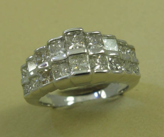 Appraisal: DIAMOND AND FOURTEEN KARAT WHITE GOLD RING set with princess-cut