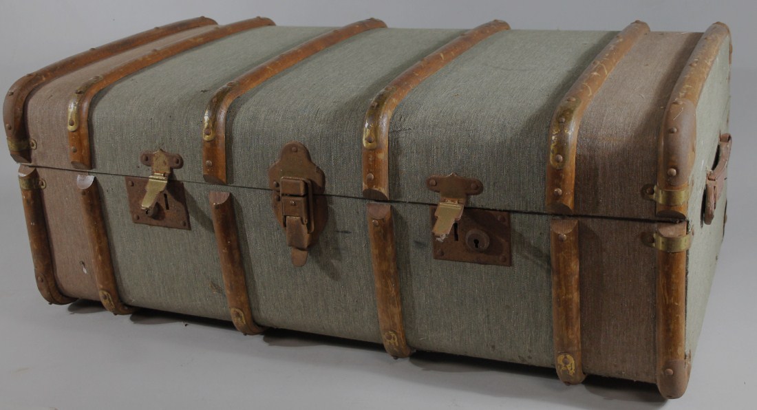 Appraisal: An early thC wooden bound top travel trunk with a