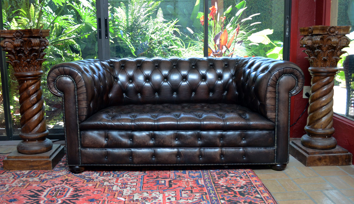 Appraisal: BROWN LEATHER CHESTERFIELD SOFA Tufted brown leather on castors No