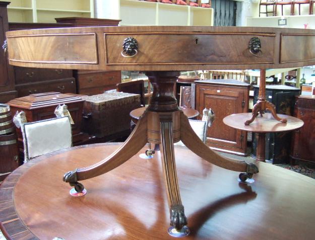 Appraisal: A George III style mahogany drum library table the tooled