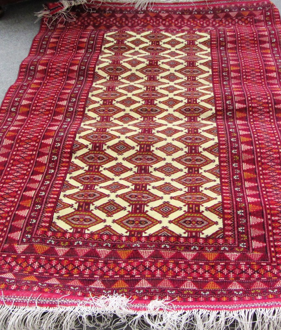 Appraisal: A Turkman rug the ivory field with columns of diamond