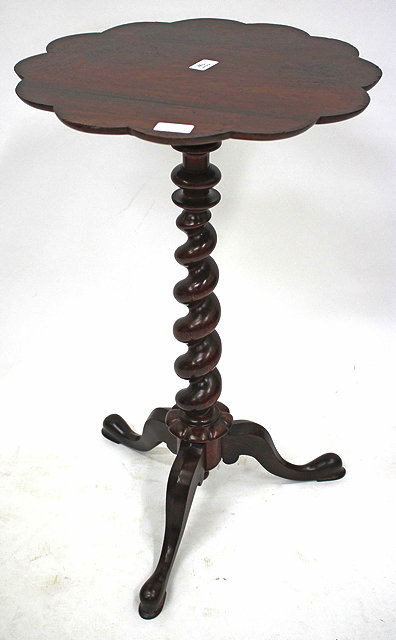 Appraisal: A VICTORIAN ROSEWOOD WINE TABLE with a shaped top and