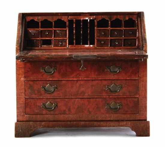 Appraisal: Miniature mixed-wood slant-front desk rectangular top over fallfront lid opening